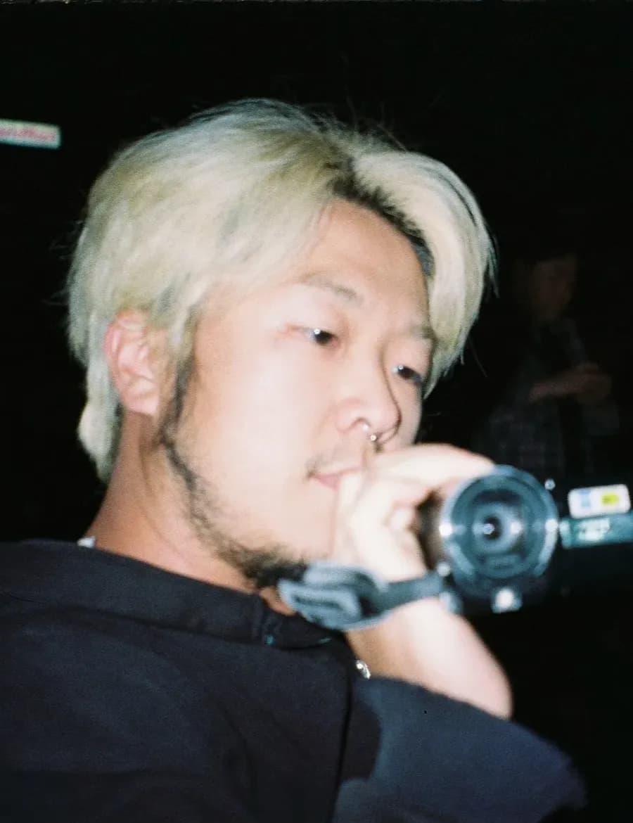 Director Park Chichi filming with a camcorder