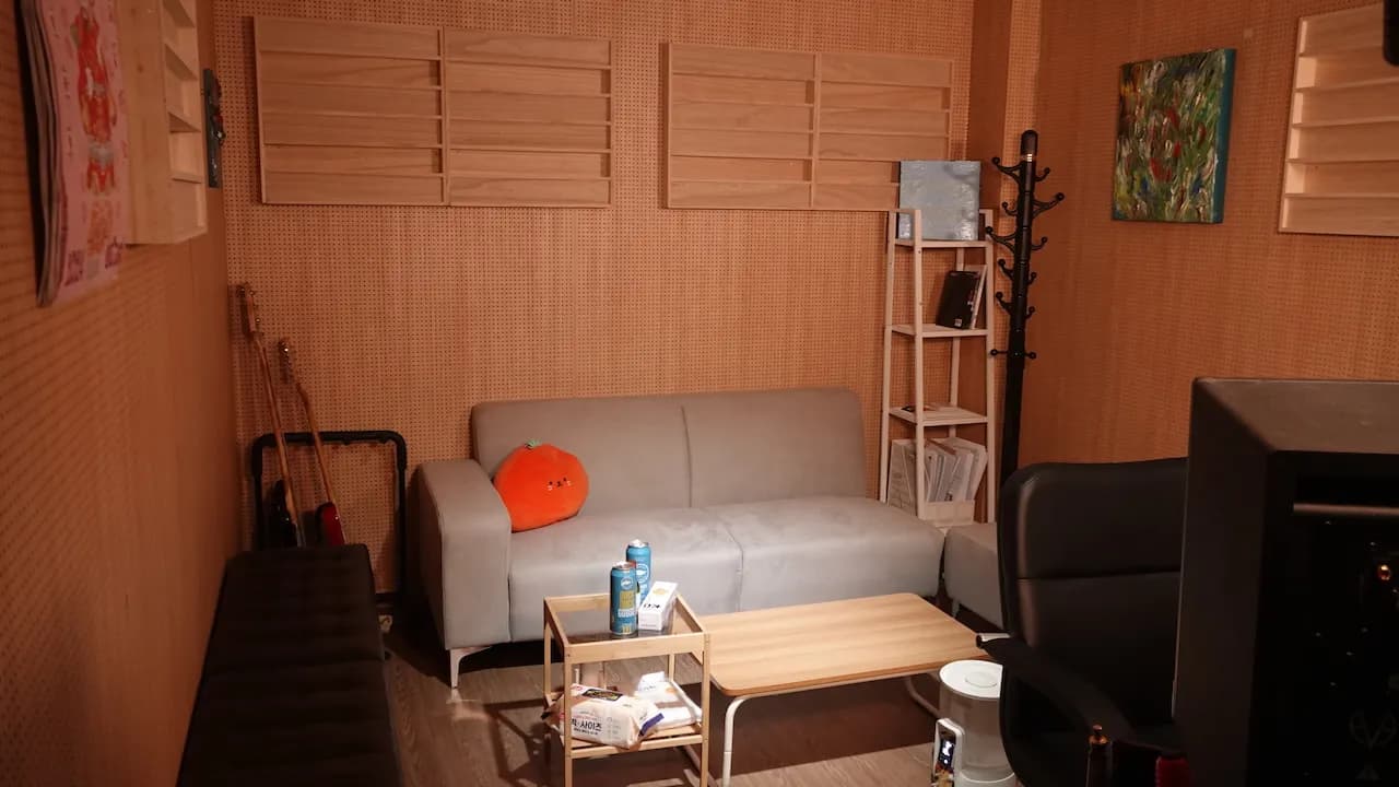 Studio NOL lounge area with sofa and acoustic wall panels